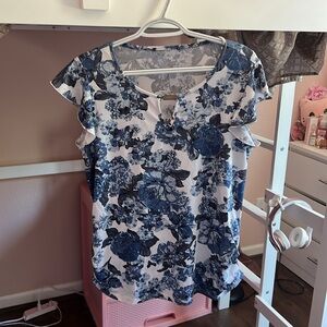 Blue flower patterned top with ruffled sleeves and v chest